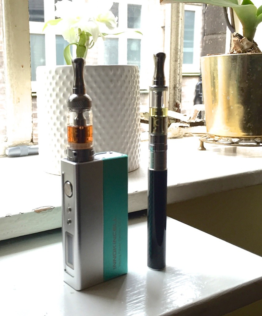 The thin stick is my first starter kit - the Aspire K1, which is easy to use and and carries a charge that lasts me all day. It's filled with a delicious juice called Lime Cola. Quite limey with just a hint of a cola taste. Very refreshing to use all day. The bigger beast produces bigger clouds of rich, flavoured vapour. It's an Aspire Nautilus tank, on a Innokin 'Disruptor' variable wattage battery. The golden liquid in the chamber is called Rosso - a rich, tangy blood-orange, sweet honey, and blackberry. My favourite breakfast vape. 